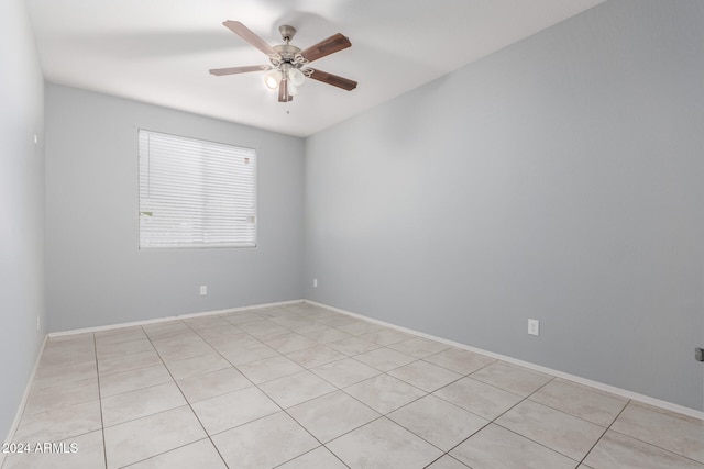 empty room featuring ceiling fan and light tile patterned floors