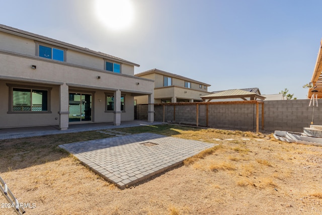 back of property featuring a patio