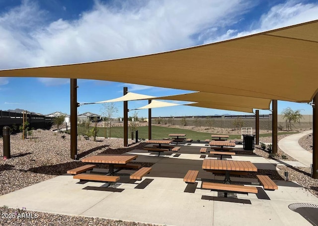 surrounding community featuring fence and a patio area