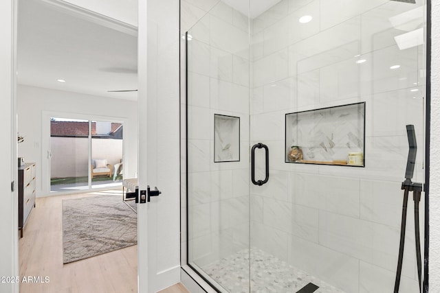 bathroom featuring hardwood / wood-style flooring and walk in shower