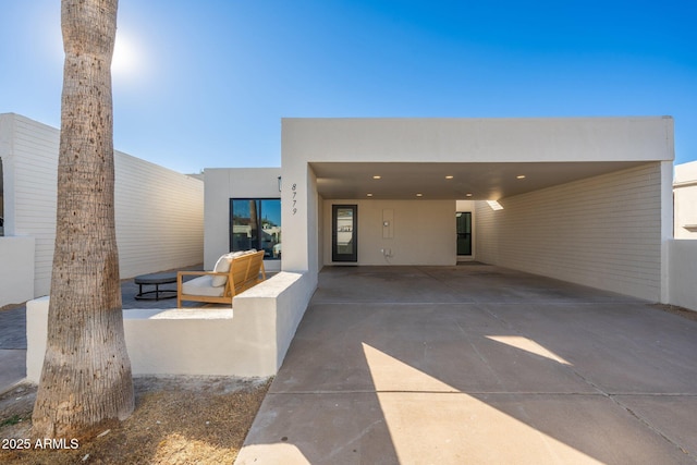 rear view of property with a carport