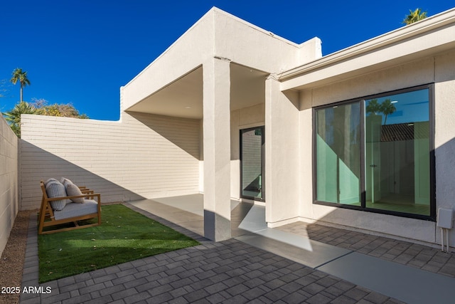 property entrance featuring a patio area