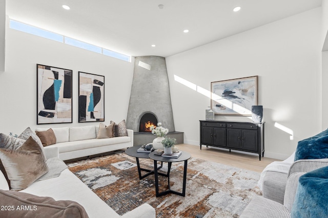 living room featuring a fireplace and light hardwood / wood-style flooring