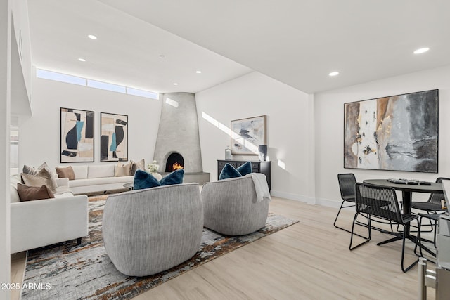 living room featuring a fireplace and light wood-type flooring