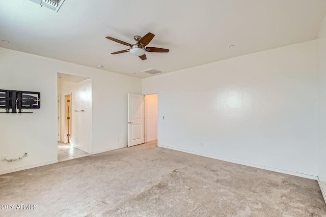 carpeted empty room featuring ceiling fan