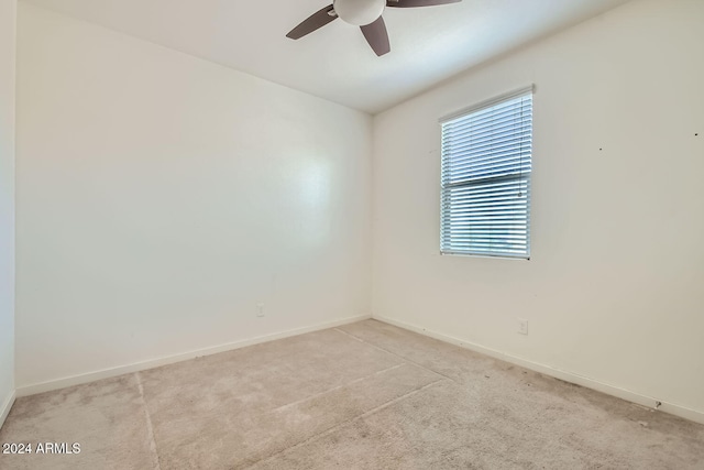 unfurnished room featuring ceiling fan and light colored carpet