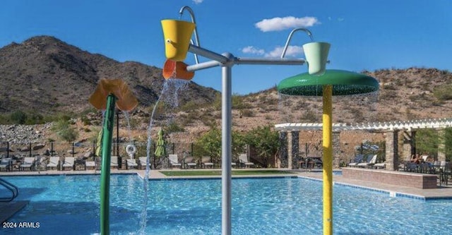 view of swimming pool featuring a mountain view