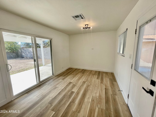 spare room featuring light hardwood / wood-style floors