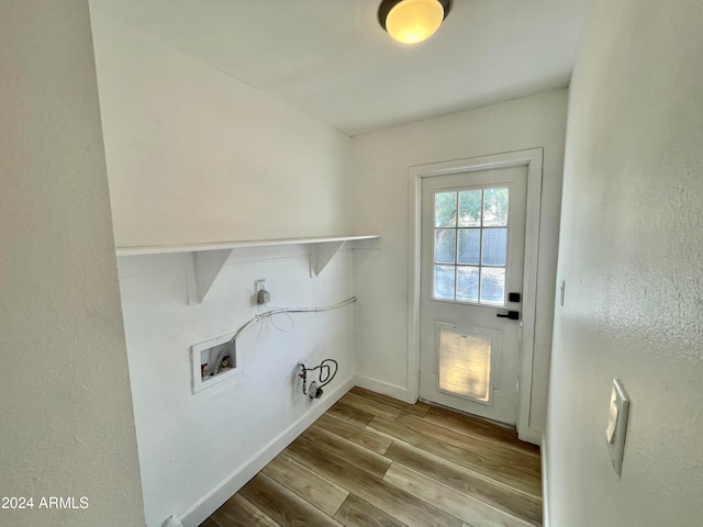 laundry area with electric dryer hookup, hookup for a gas dryer, hookup for a washing machine, and light hardwood / wood-style flooring