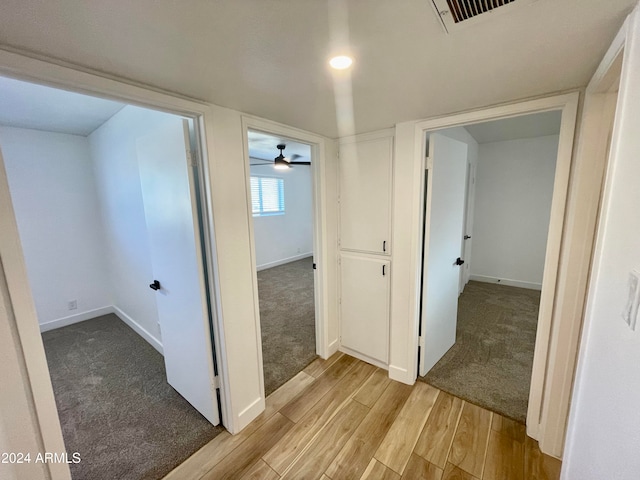 corridor with light hardwood / wood-style floors