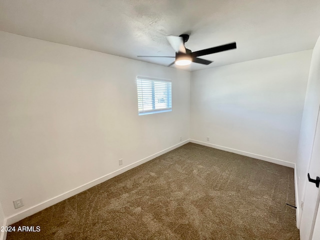 empty room with ceiling fan and carpet