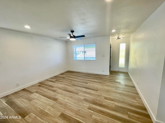 unfurnished room featuring ceiling fan and light hardwood / wood-style flooring