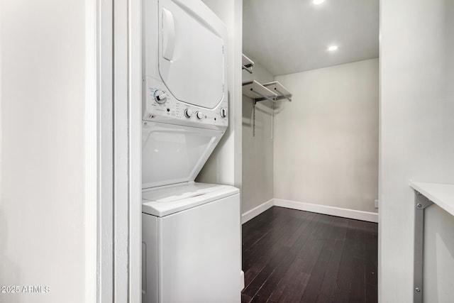 washroom featuring dark wood-style floors, baseboards, stacked washer and dryer, laundry area, and recessed lighting