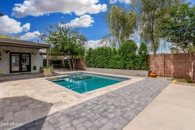 view of swimming pool featuring a fenced in pool, a fenced backyard, and a patio