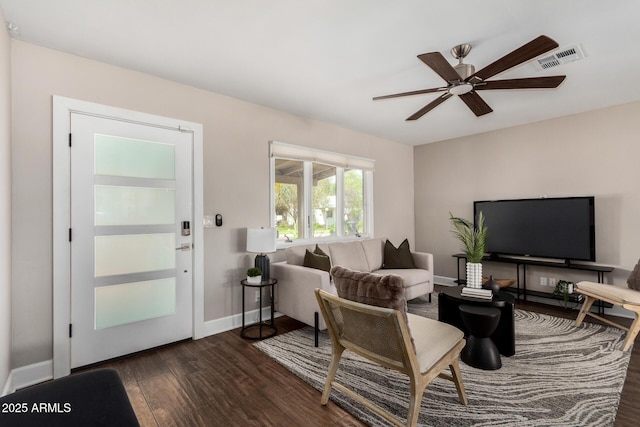 living room with baseboards, visible vents, ceiling fan, and dark wood finished floors