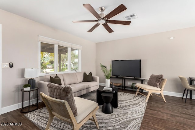 living area featuring wood finished floors, visible vents, a ceiling fan, and baseboards