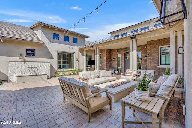 view of patio featuring an outdoor living space with a fire pit