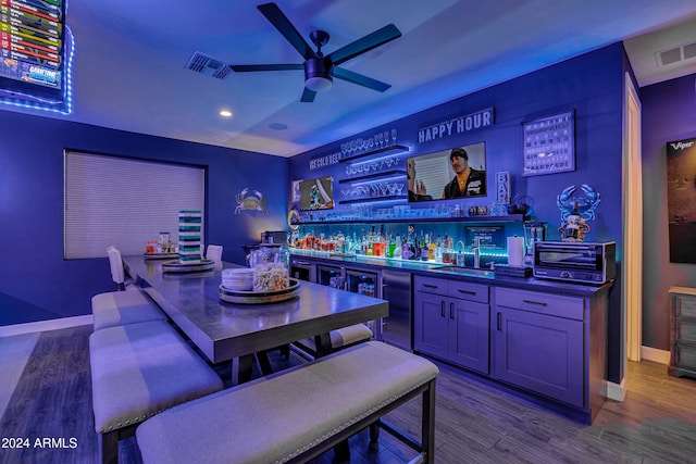 interior space featuring hardwood / wood-style flooring, wet bar, and ceiling fan