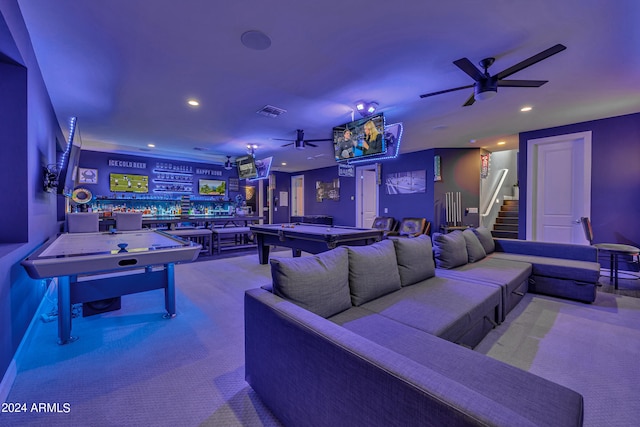 interior space with ceiling fan, pool table, bar area, and light colored carpet