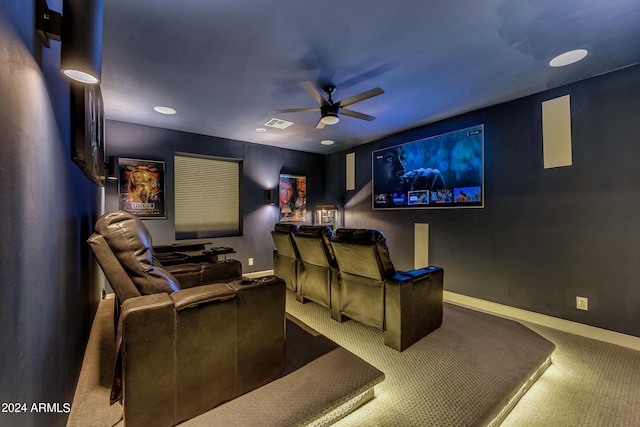 carpeted cinema featuring ceiling fan