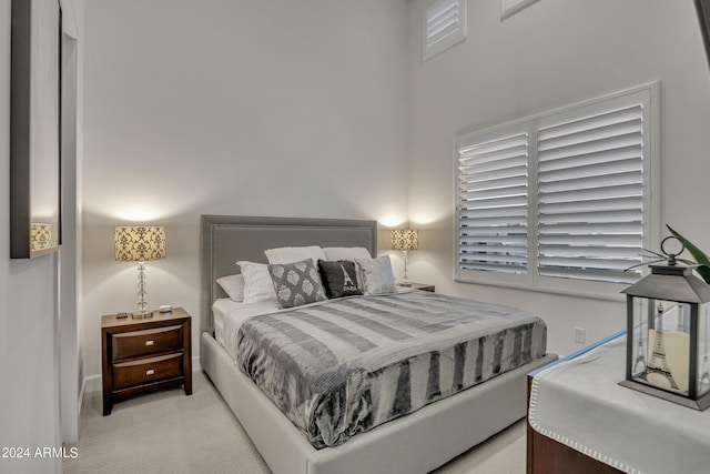 bedroom featuring light colored carpet