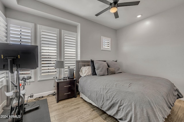 bedroom featuring multiple windows, ceiling fan, and light hardwood / wood-style floors