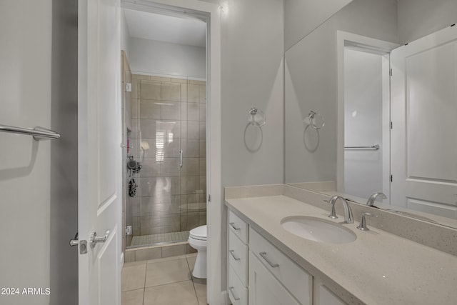 bathroom featuring tile patterned floors, vanity, toilet, and an enclosed shower