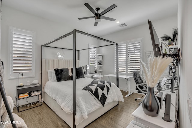 bedroom with hardwood / wood-style floors and ceiling fan