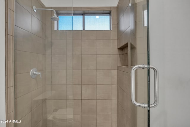 bathroom featuring a shower with door