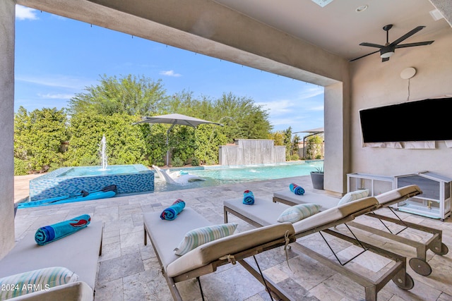 view of patio / terrace with a swimming pool with hot tub, pool water feature, and ceiling fan