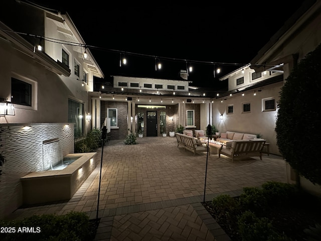 patio at twilight featuring an outdoor living space