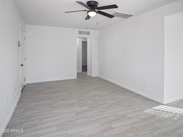 empty room featuring light hardwood / wood-style flooring and ceiling fan