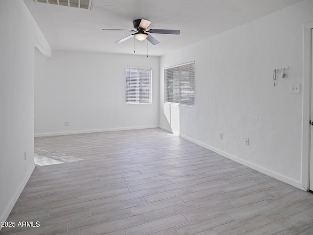 empty room featuring ceiling fan and light hardwood / wood-style floors