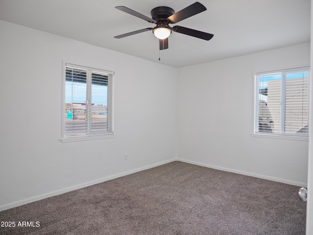 spare room featuring ceiling fan, carpet floors, and a wealth of natural light