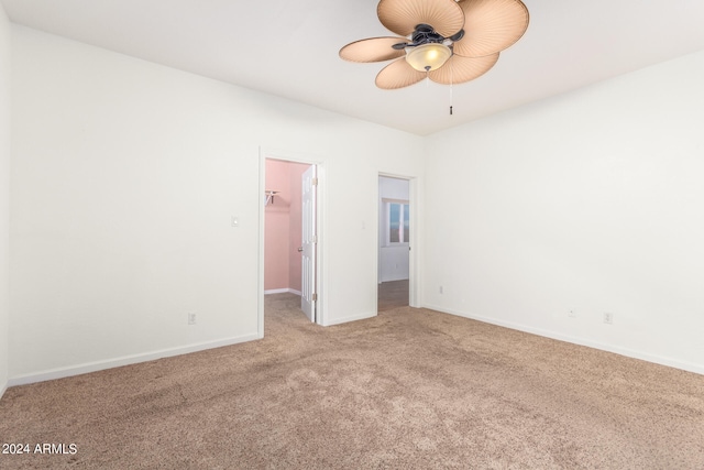 carpeted empty room featuring ceiling fan