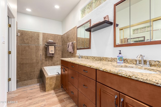 bathroom with vanity, plus walk in shower, and hardwood / wood-style floors