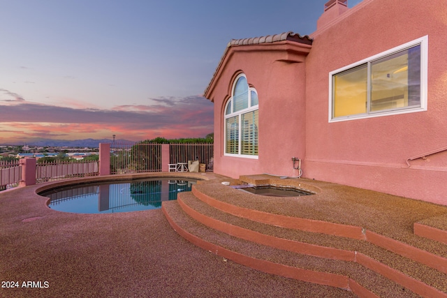 pool at dusk with a patio