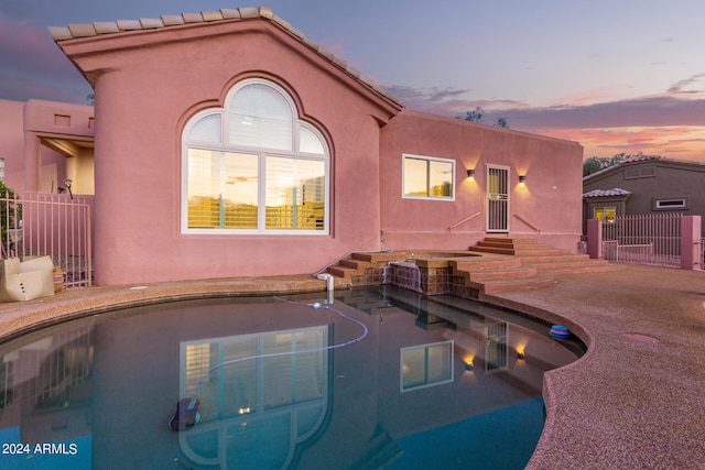 view of pool at dusk