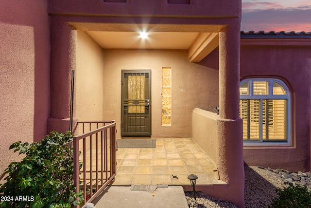 view of exterior entry at dusk