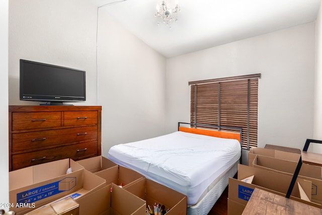 bedroom with an inviting chandelier and vaulted ceiling