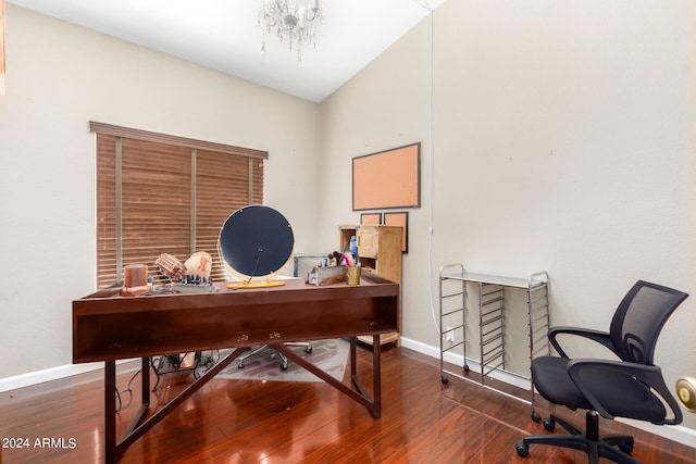 office area featuring a notable chandelier, vaulted ceiling, and dark hardwood / wood-style flooring