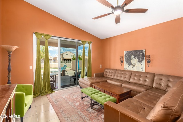 living room with lofted ceiling, ceiling fan, and light tile patterned floors