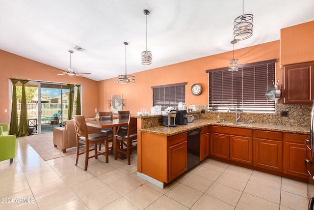 kitchen featuring ceiling fan, light stone counters, sink, decorative light fixtures, and black dishwasher