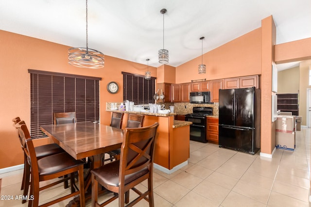 kitchen featuring tasteful backsplash, high vaulted ceiling, light stone countertops, pendant lighting, and black appliances