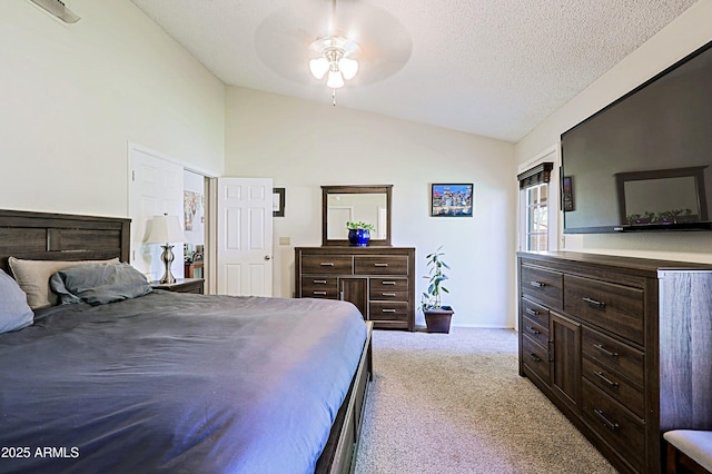 bedroom with lofted ceiling, a ceiling fan, carpet floors, and a textured ceiling