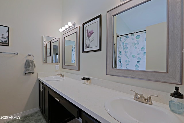 full bathroom with double vanity, a sink, and baseboards