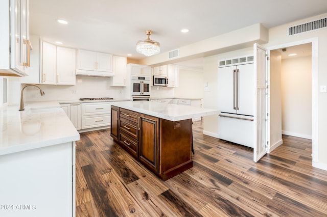 kitchen featuring a center island, stainless steel appliances, sink, and dark wood-type flooring