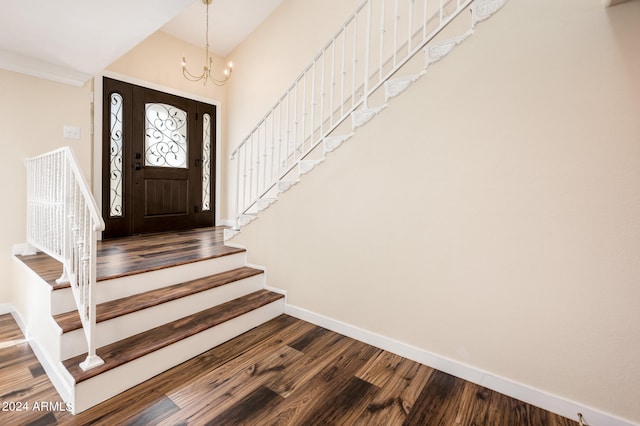 foyer with hardwood / wood-style floors and an inviting chandelier