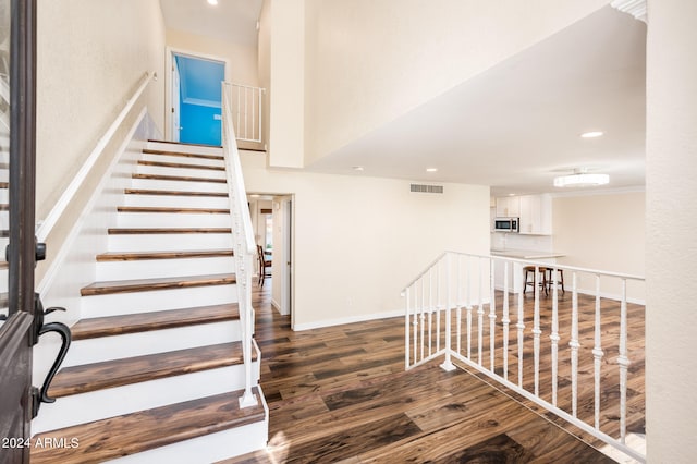 stairway featuring hardwood / wood-style flooring