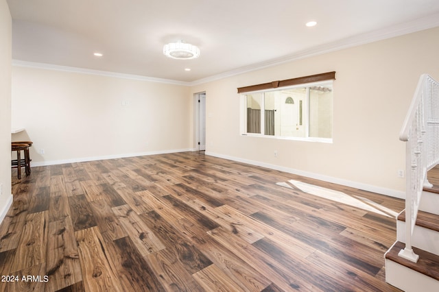 unfurnished living room with wood-type flooring and crown molding